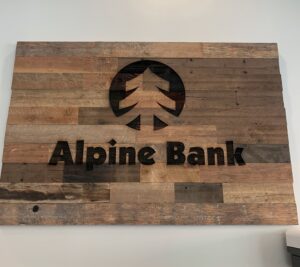 Laser burned alpine bank mural in reclaimed wood